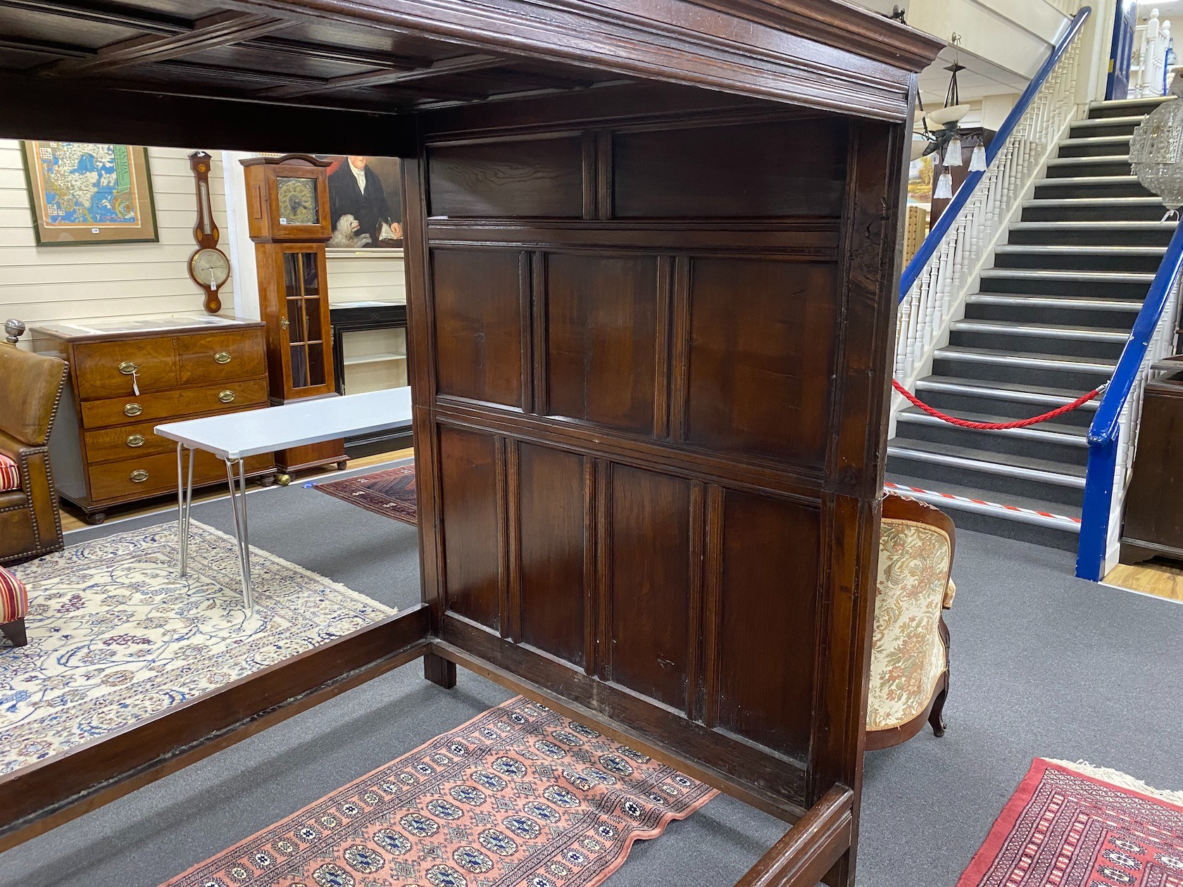 An 18th century style oak four poster bed with panelled canopy, width 162cm, length 221cm, height 194cm